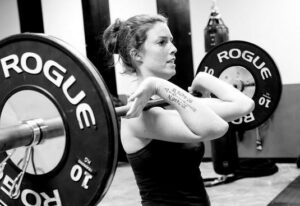 A woman lifting a barbell at a Wichita Personal Training Studio.