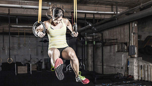 A woman doing a CrossFit exercise in a gym.