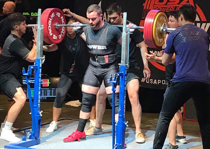 BLAKE REDENBAUGH doing squats at a competition.